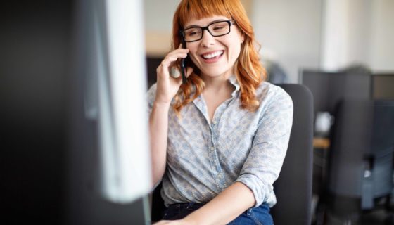 Smiling female professional working at her desk